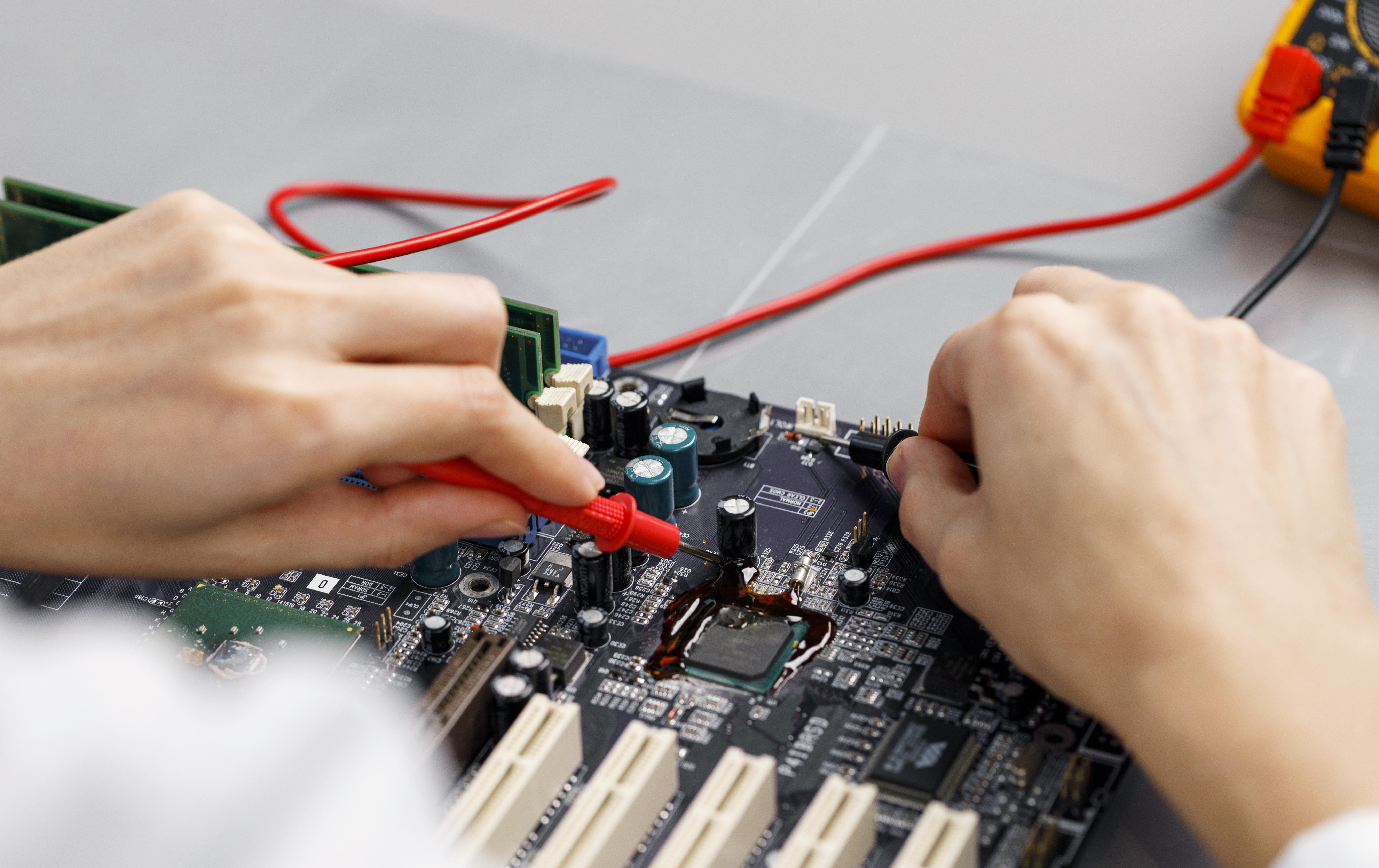 high-angle-female-technician-repairing-computer-motherboard